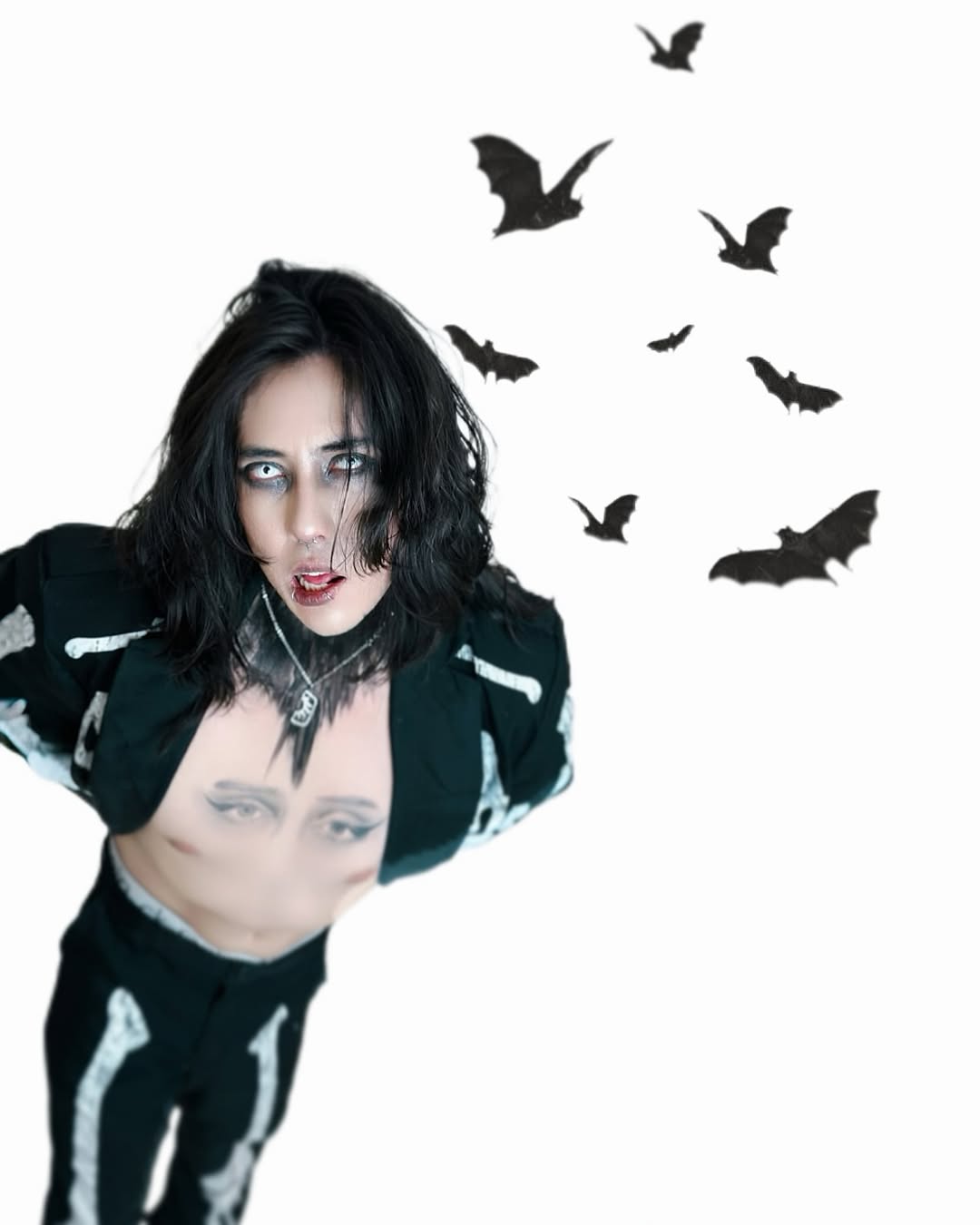 Johan Peraza posing in an open skeleton jacket on a white background surrounded by flying bats illustration