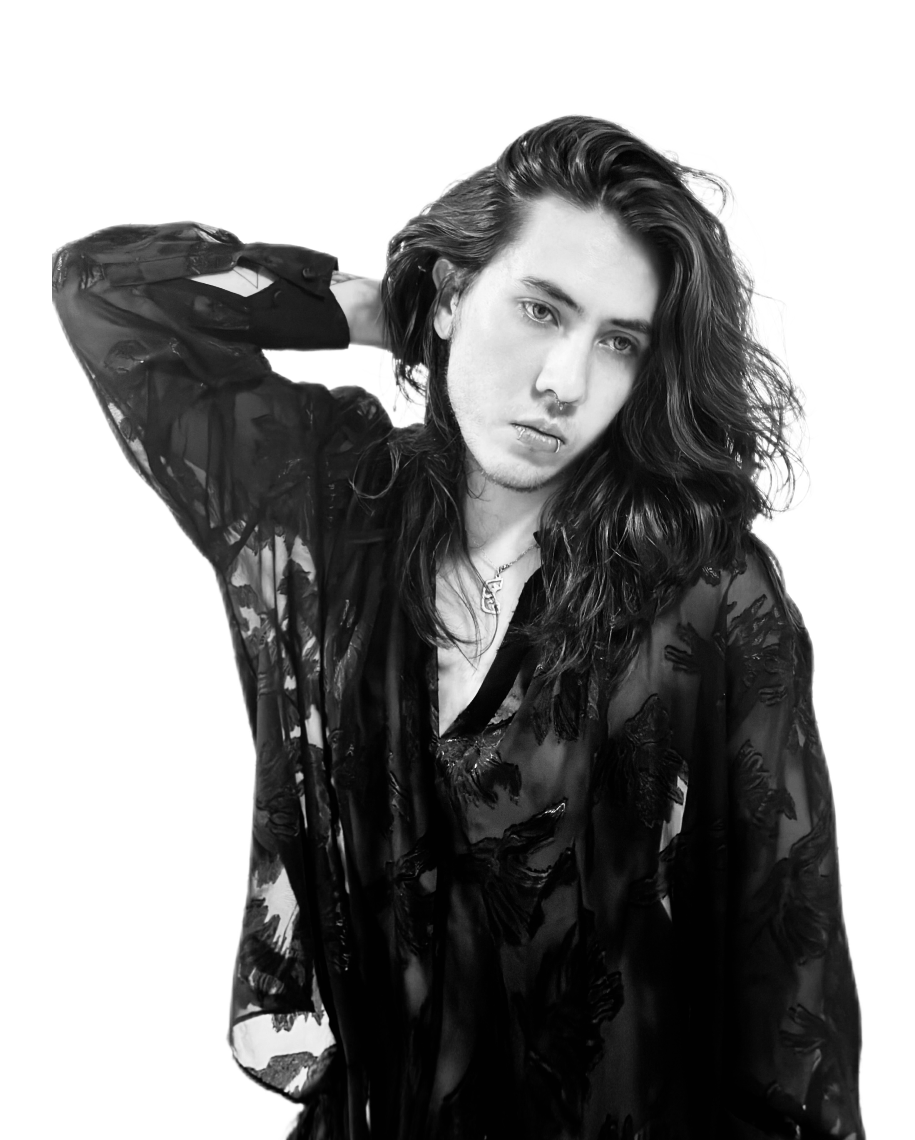 Johan Peraza, dramatic black and white editorial portrait with long hair parted in the middle