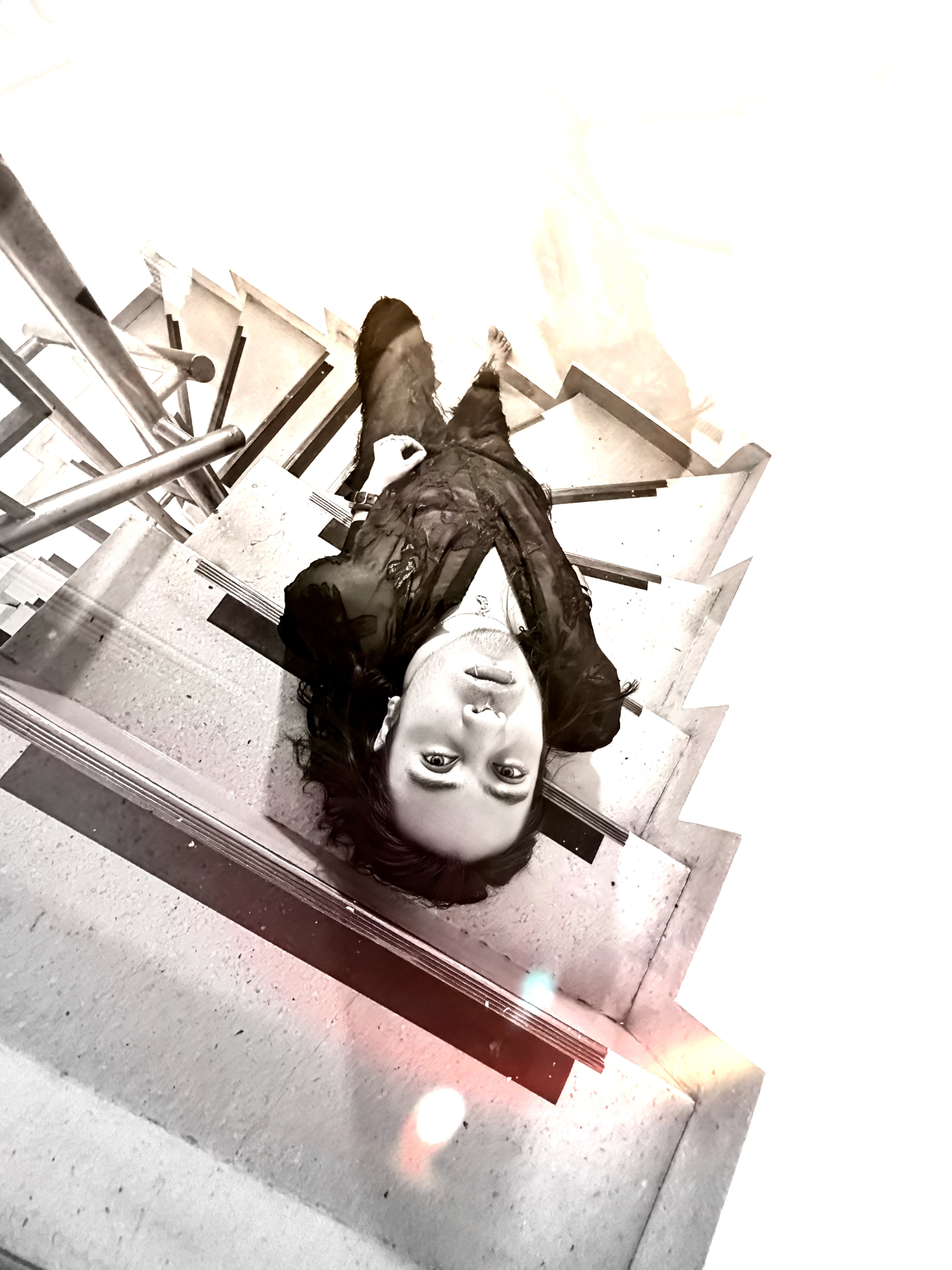 Johan Peraza, overhead high-angle creative portrait looking up from a concrete staircase