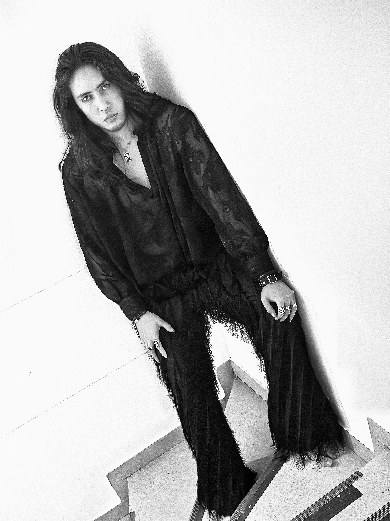 Johan Peraza, full-length black and white fashion portrait in wide-leg trousers on stairs