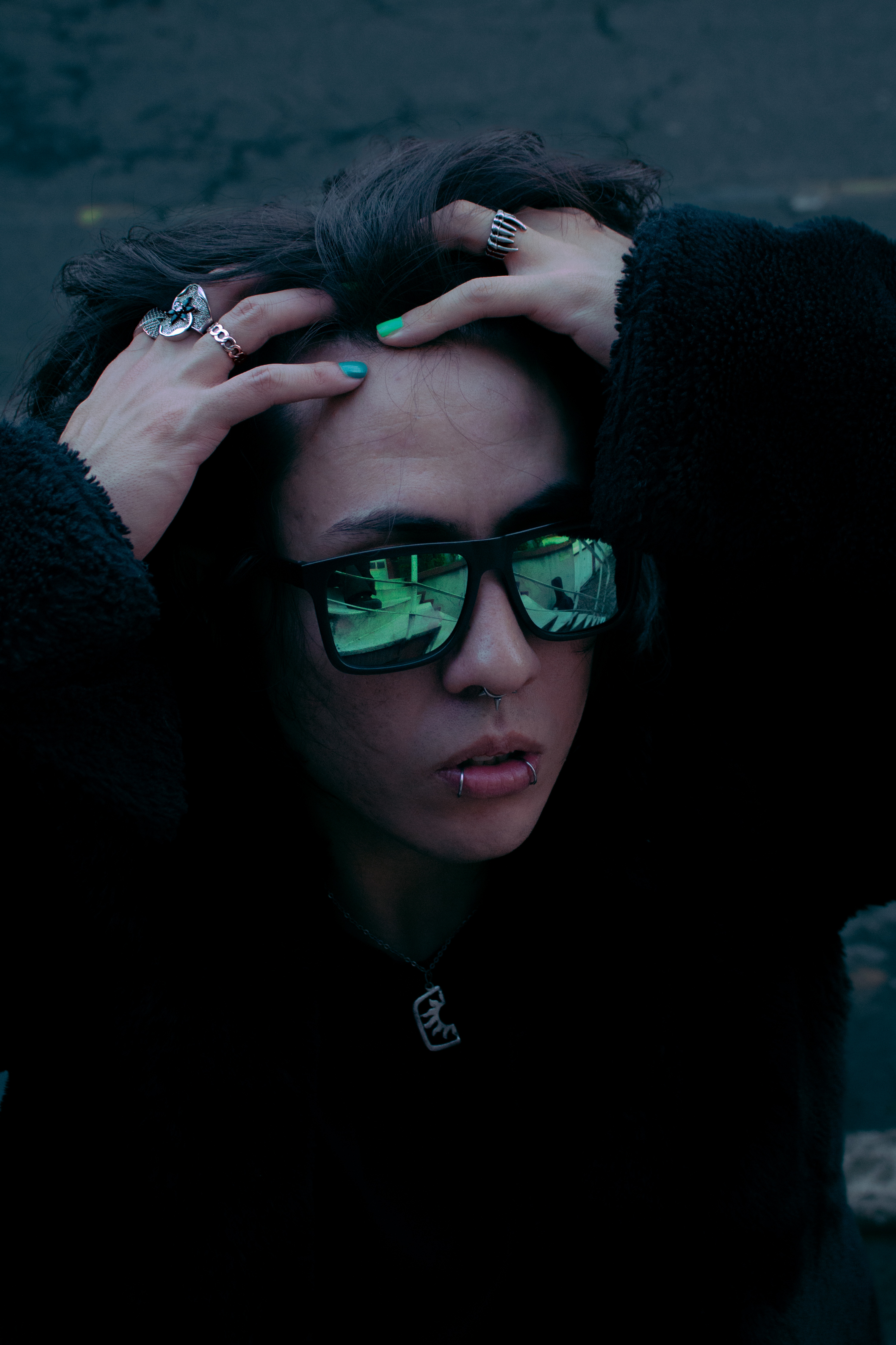 Johan Peraza, cinematic close-up shot leaning forward with reflective sunglasses