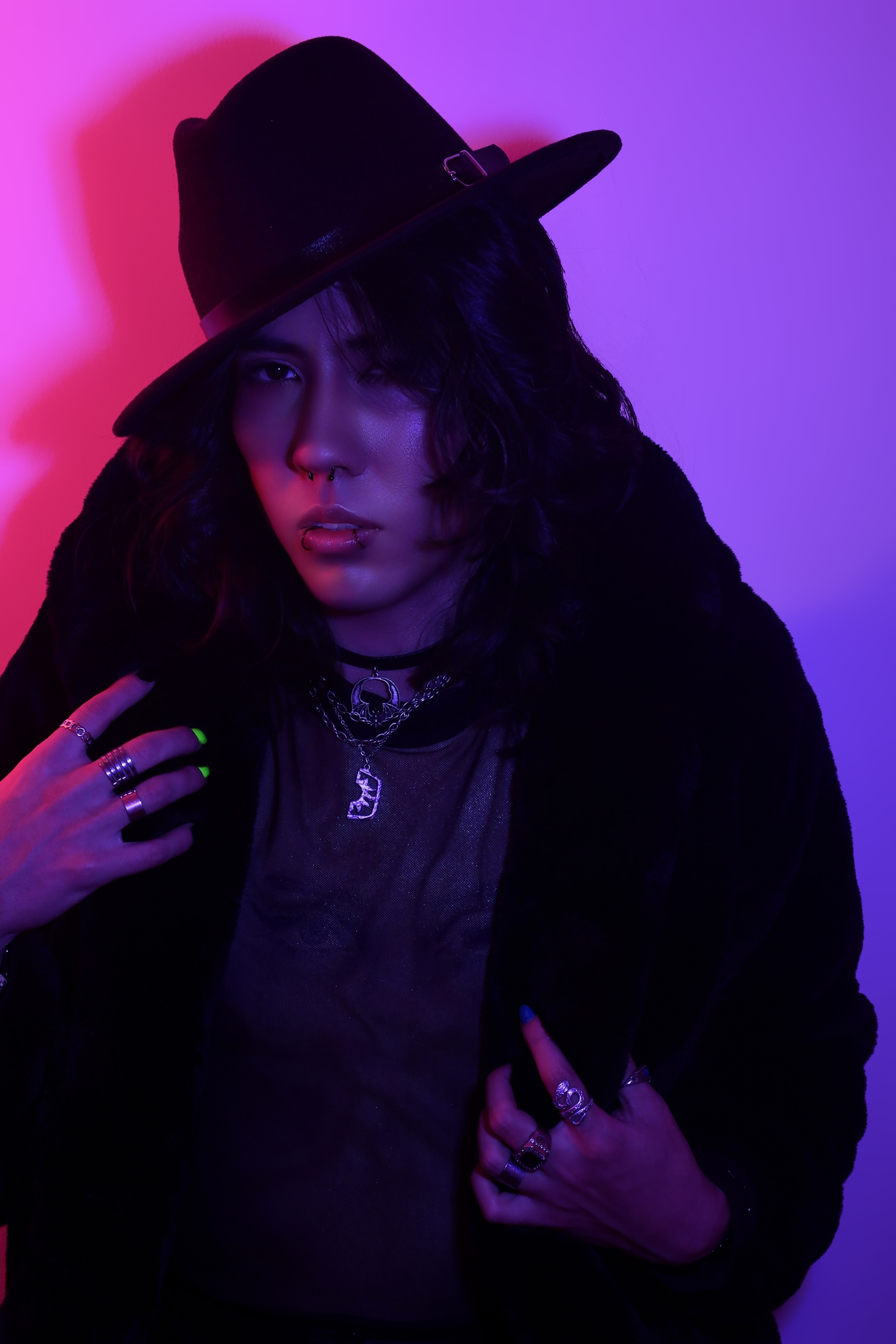Johan Peraza, creative artist portrait illuminated by neon purple and pink split lighting